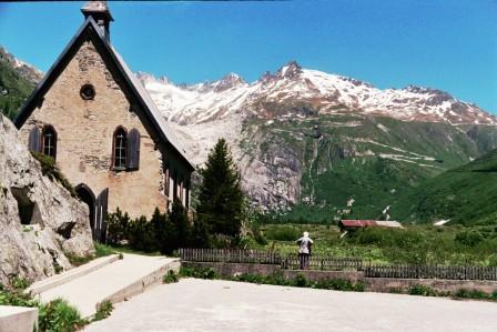 The church at Gletch with the Furkapass behind